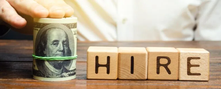 Roll of $100 bills and the word "hire"