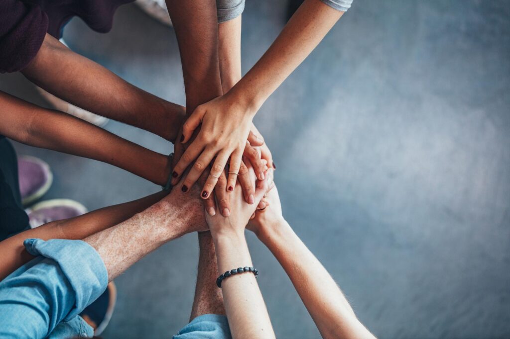 Group of people with their hands in