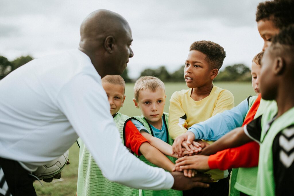 Coach talking to youth sports team