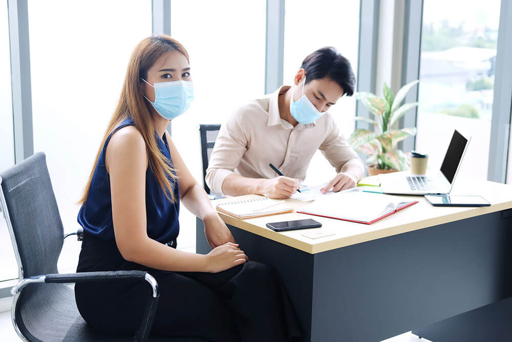 Two coworkers in masks