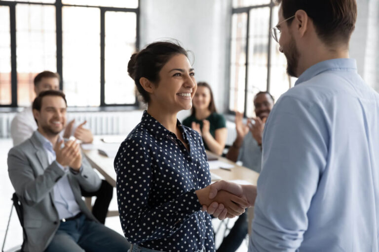 Boss shaking hands with promoted employee