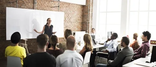 Woman giving a presentation before a group of employees