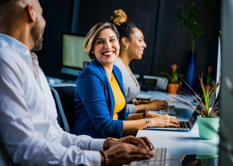 a group of people sitting at a desk